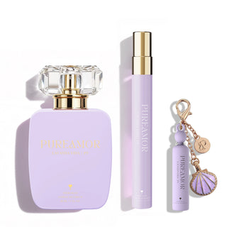 Purple perfume set with bottle, travel spray, and keychain on a white background