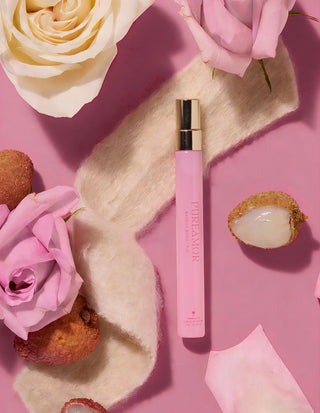 Pink 12ml travel spray with flowers and cookies on a pink background