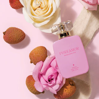 Pink 'PUREAMOR' 30ml perfume bottle with lychees and roses on a pink background
