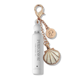 White 2ml keychain with rose gold accents and shell charm on a white background