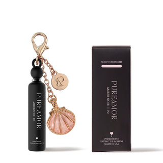 PureAmor Amber Noir pheromone perfume 2ml keychain, surrounded by amber crystals and vanilla pods, creating a warm, luxurious scent