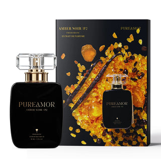 PureAmor Amber Noir pheromone perfume 30 ml bottle displayed beside illustrated packaging with amber and vanilla artwork.