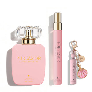 Pink 'PUREAMOR' perfume set with bottle, travel spray, and keychain on a white background