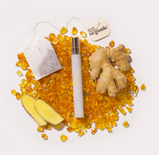 12ml travel spray next to Tea bag, ginger root, and organic label on a white background