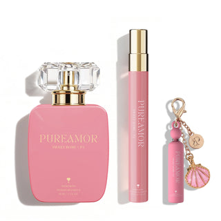Pink 'PUREAMOR' perfume set with perfume bottle, travel spray, and keychain on a white background