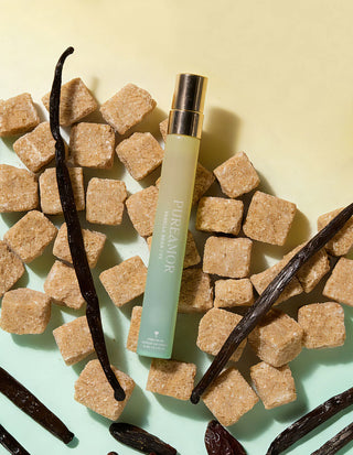 12ml travel spray with vanilla beans and sugar cubes on a light green background