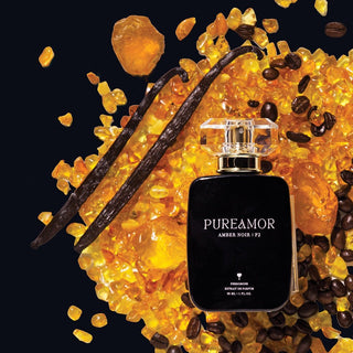 Perfume 30ml bottle labeled 'PUREAMOR' surrounded by amber, vanilla beans, and coffee beans on a black background.