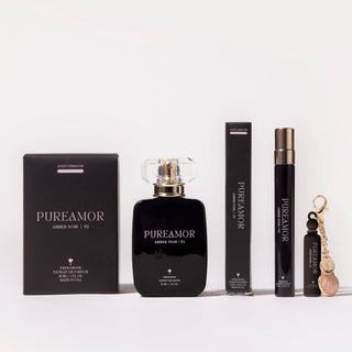 PUREAMOR perfume set with black bottle, travel spray, and keychain on a white background