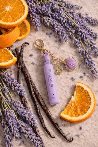 Lavanda Vida pheromone perfume 2 ml keychain surrounded by orange slices and lavender, creating a refreshing