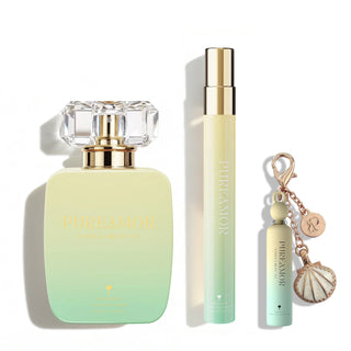 A perfume kit containing perfume bottle, travel spray, and keychain displayed in front of white background.